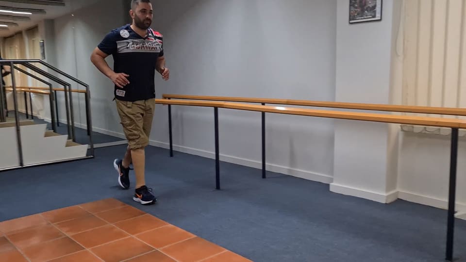 Ασθενής με τεχνητό πόδι περπατά στον χώρο εκμάθησης βάδισης του εργαστηρίου μετά τον ακρωτηριασμό